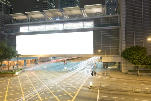 Big Empty Billboard at night in city with busy traffic — Stock Photo, Image
