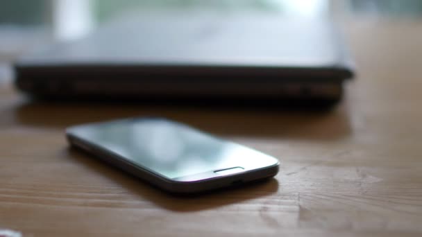 Laptop and mobile phone on table — Stock Video