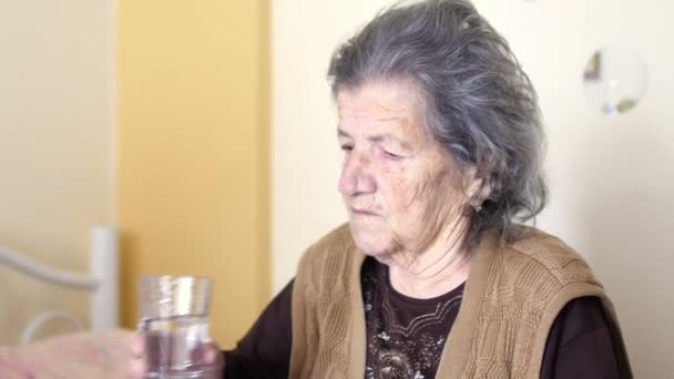 Unhealthy old woman get pills — Stock Video