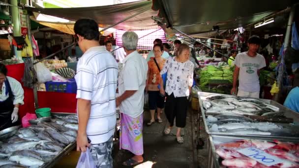 Train passing through folding umbrella market — Stock Video