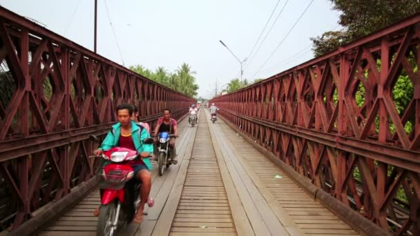 Motorbikes crossing historical bridge — Stock Video