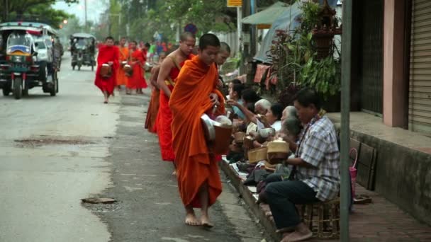 People give rice to monks as gift and get their blessing — Stock Video