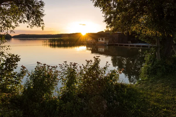 Landscape on a lake with trees and reeds and boatshouse — Stock Photo, Image