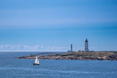Lighthouses and sailboat on an archipelago island in Norway. clipart