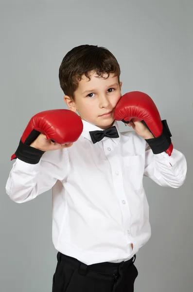 Boy in white shirt and bow tie in fighting stance