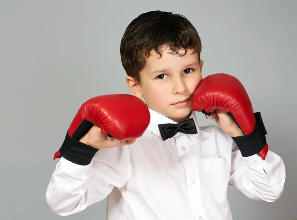 Boy in white shirt and bow tie in fighting stance