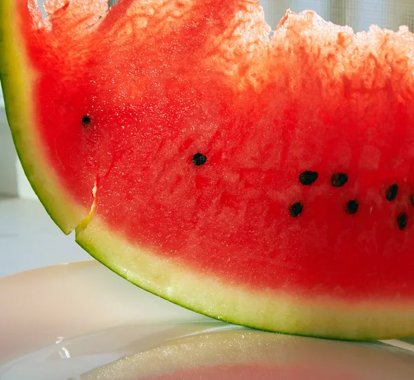 Slice of juicy watermelon on white plate — Stock Photo, Image