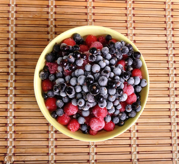 Heap of frozen black currant and cherry in a plate — Stock Photo, Image