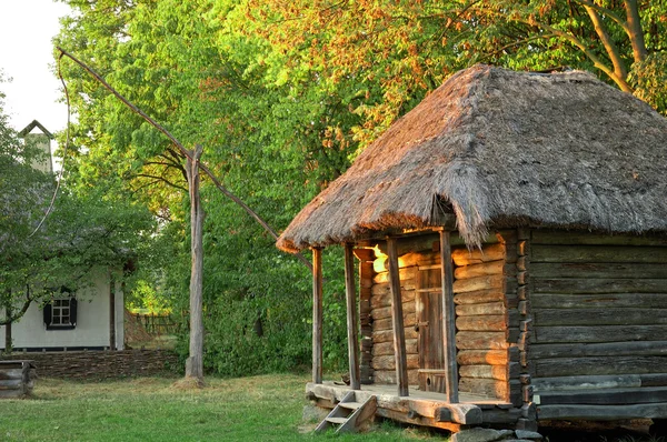 Evening on yard with wooden house — Stock Photo, Image