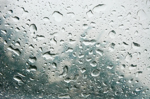 Chuva cai textura na superfície transparente — Fotografia de Stock