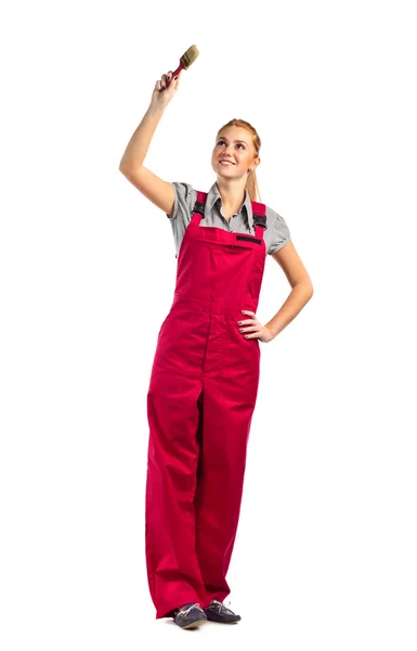 Young happy woman in red jumpsuit with paint brush — Stock Photo, Image