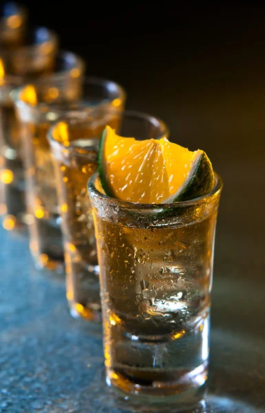 Tequila and lime on glass table — Stock Photo, Image