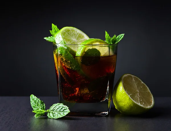 cocktail Cuba libre with lime and peppermint leaves