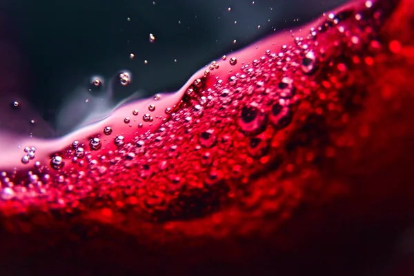 Red wine on black background — Stock Photo, Image