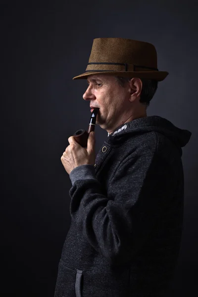 Portrait of a man with a smoking pipe — Stock Photo, Image