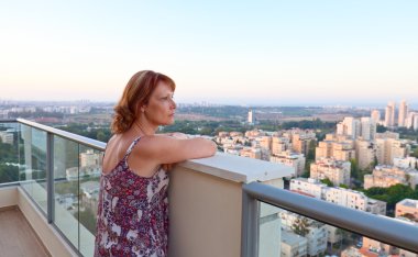 Şehir merkezinde bir balkonda kadın
