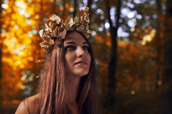 The young beautiful woman in autumn forest