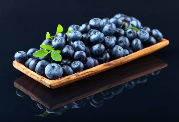 Blueberries in wooden dish — Stock Photo, Image