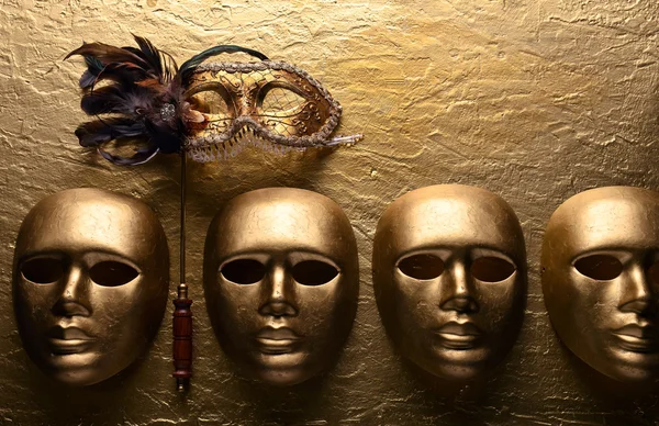 Carnival masks on a golden background — Stock Photo, Image