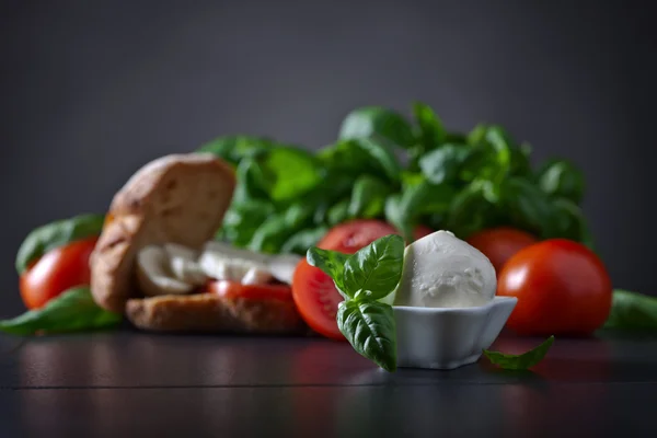 Mozzarella with tomato and basil — Stock Photo, Image