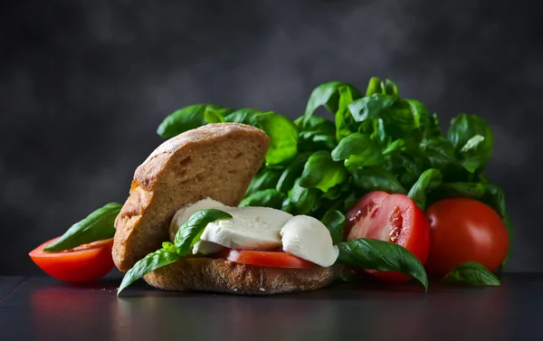 Sandwich with mozzarella, tomato and basil — Stock Photo, Image