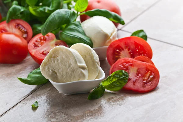 Mozzarella with tomato and basil — Stock Photo, Image