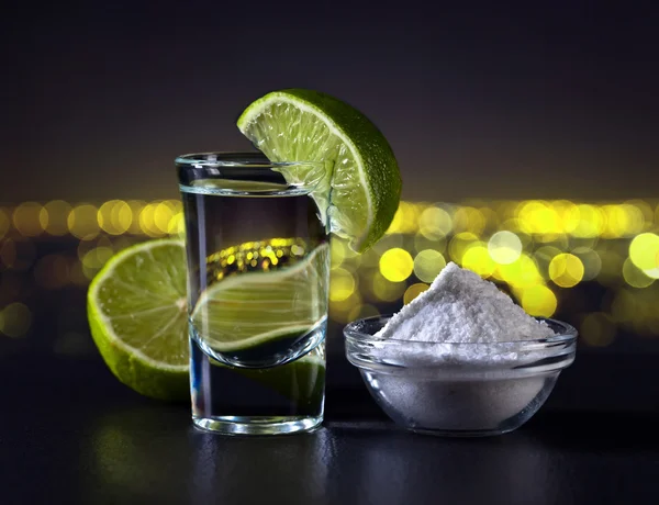 Gold tequila on a background of night city — Stock Photo, Image