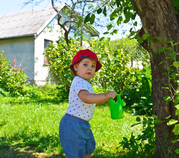 Happy little girl playing in the garden — Stock Photo, Image