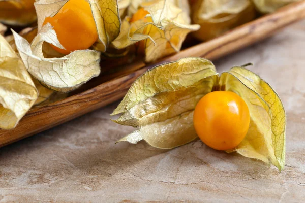 Physalis in wooden dish — Stock Photo, Image