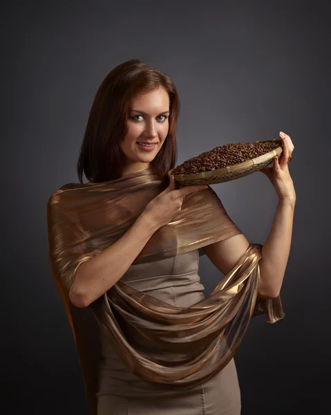 Young beautifu woman with coffee beans — Stock Photo, Image