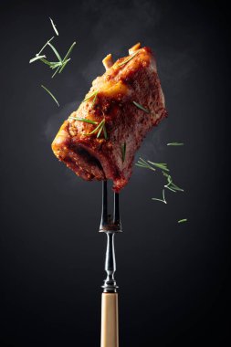 Izgara domuz pirzolası. Siyah zemin üzerine biberiye serpiştirilmiş ızgara et..