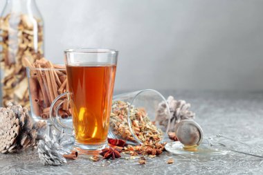 Tarçınlı, anasonlu ve kurutulmuş otlu Noel çayı. Gri arkaplanlı baharatlı bitki çayı..