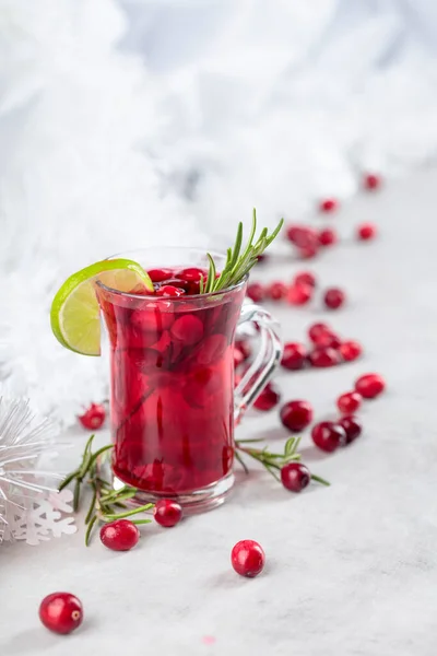 Christmas cranberry drink with berries, lime, and rosemary. Copy space.