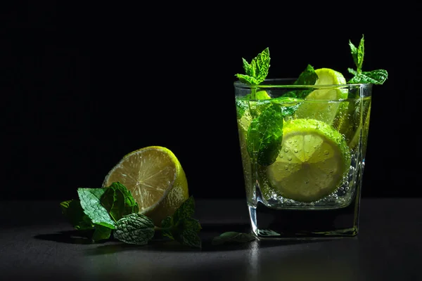 Carbonated drink with fresh mint and lime slices.