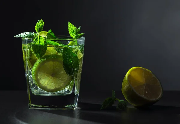 Carbonated drink with fresh mint and lime slices.