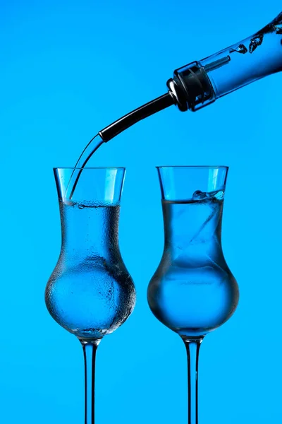 Vodka Poured Bottle Frozen Glasses Ice Frozen Glasses Blue Background — Stock Photo, Image