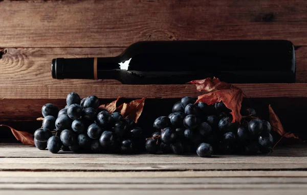 Botella Vino Tinto Racimo Uvas Sobre Una Vieja Mesa Madera —  Fotos de Stock