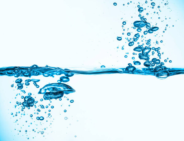 Blue water splash wave surface with bubbles of air.