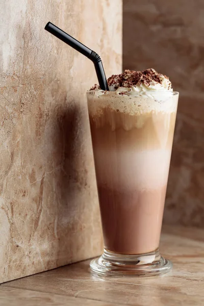 Milk coffee cocktail with whipped cream sprinkled with chocolate crumbs. Copy space.