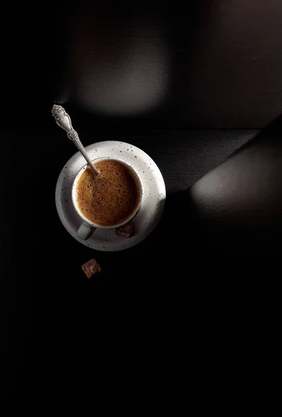 黒コーヒーと黒糖をブラックテーブルの上にホワイトカップ コピースペース付きのトップビュー — ストック写真