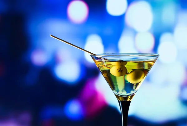 Glass with martini and green olives — Stock Photo, Image