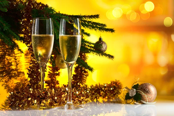 Glasses with champagne and Christmas ornaments — Stock Photo, Image