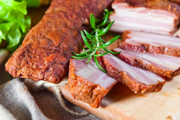 Smoked meat with rosemary — Stock Photo, Image