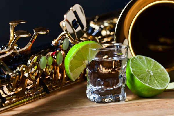Saxophone and tequila with lime — Stock Photo, Image