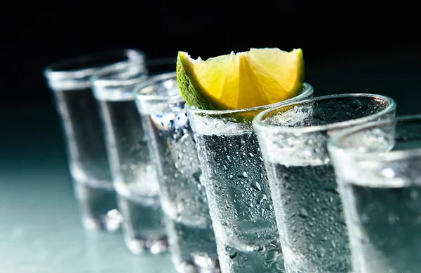 Tequila and lime on glass table — Stock Photo, Image