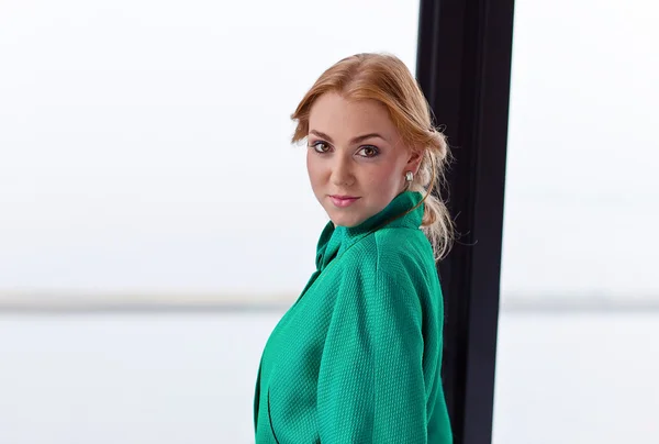 Young beautiful woman in green jacket — Stock Photo, Image