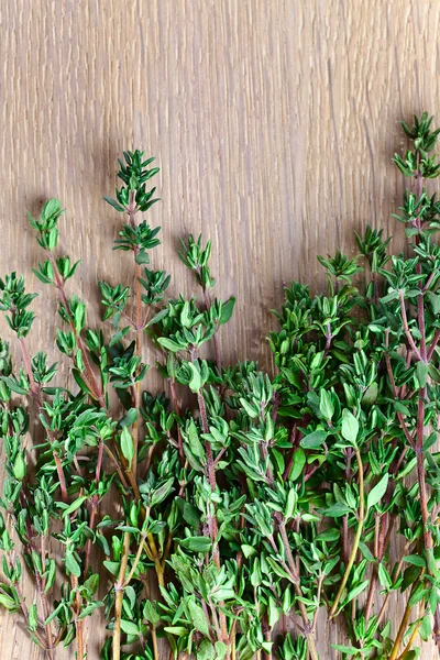 Thyme on wooden table — Stock Photo, Image