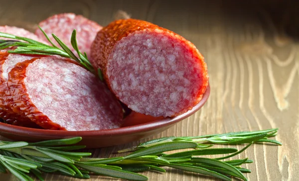 Salami with rosemary — Stock Photo, Image