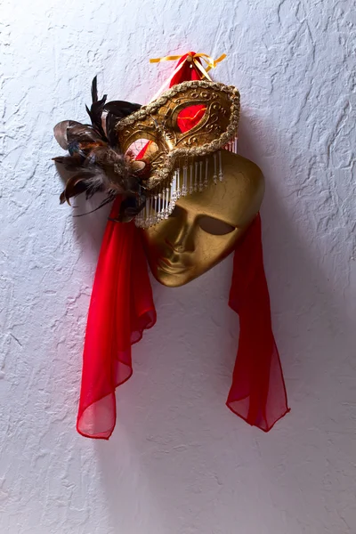 Two golden Venetian masks on a old wall — Stock Photo, Image