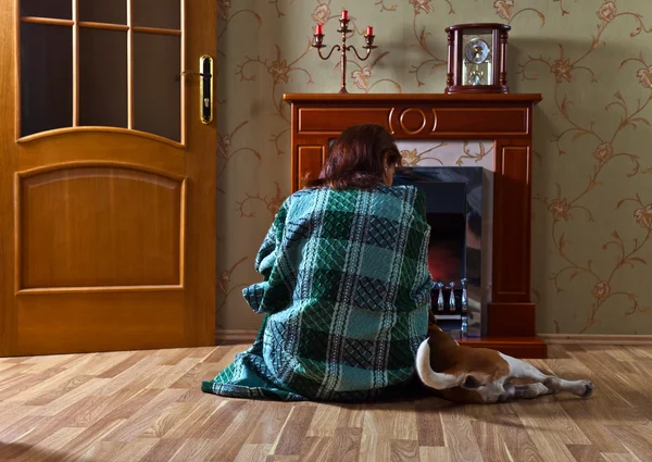 Mulher com cão perto de uma lareira — Fotografia de Stock
